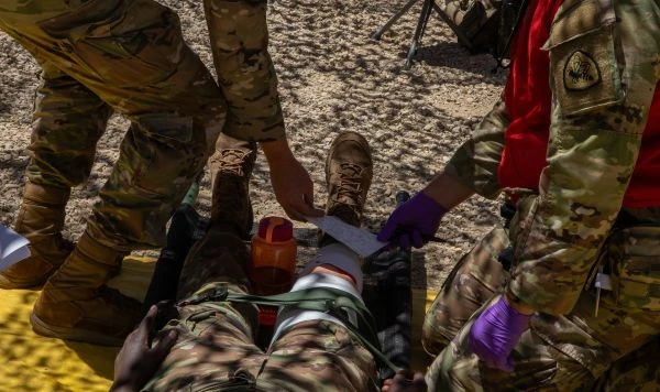 Soldiers train on first aid in a field environment