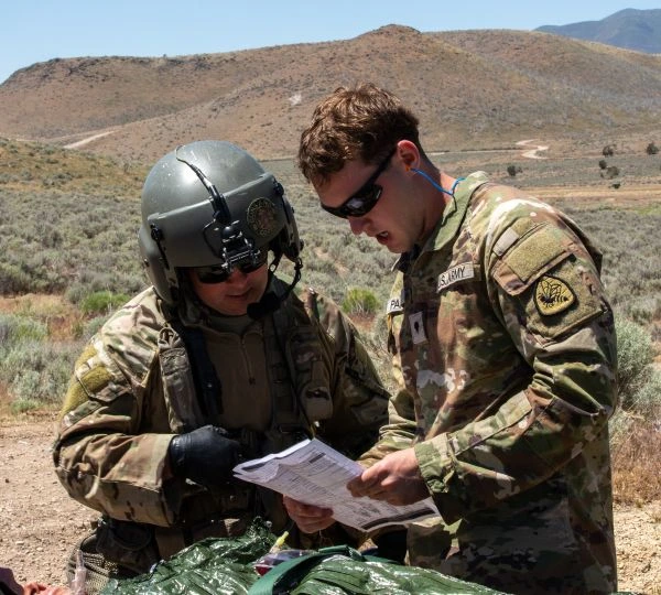 Soldiers review a sheet of paper