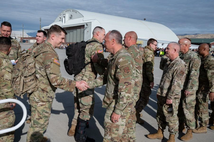 General Boyack shaking hands and welcoming back soldiers