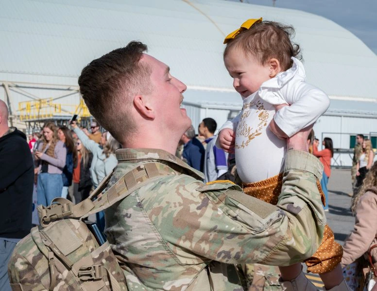 Soldier saying hi to baby after getting back