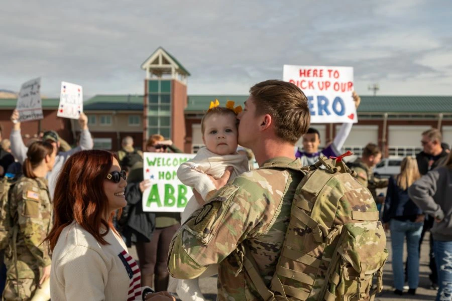 Soldier kissing baby after coming back from deployment