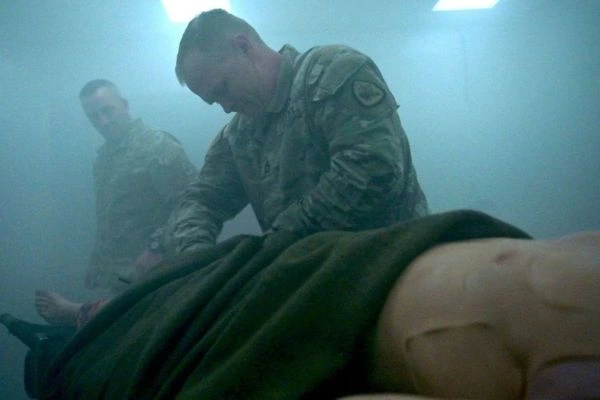 a community asset photo of soldier helping training dummy