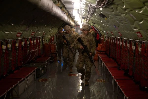 A group of soldiers is looking through a KC-135 plane, looking for valuable intelligence assets at the Utah National Guards Best Linguist Competition