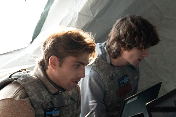 A close-up of two National Defense students inside a tent, working on computers, taking part in the Utah National Guard's Best Linguist Competition