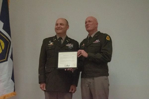 Two soldiers show a letter of appreciation