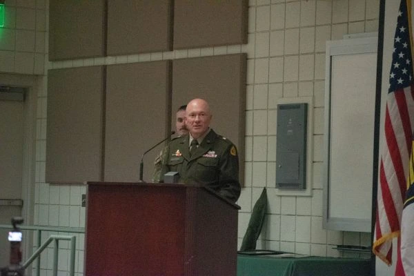 A soldier speaks at a podium