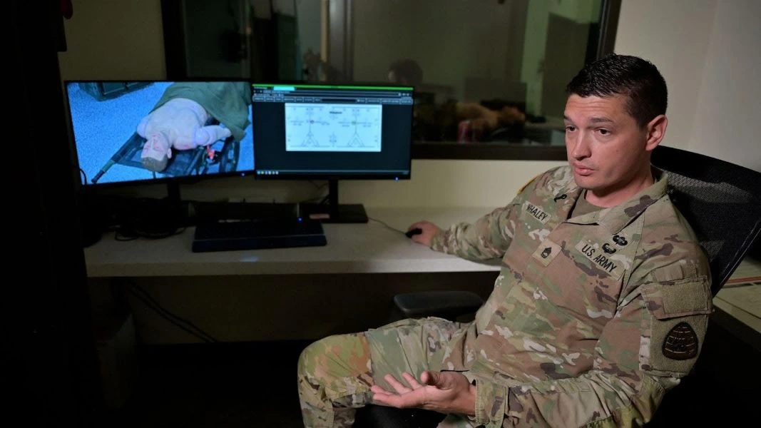 Soldier explaining simulation on a computer