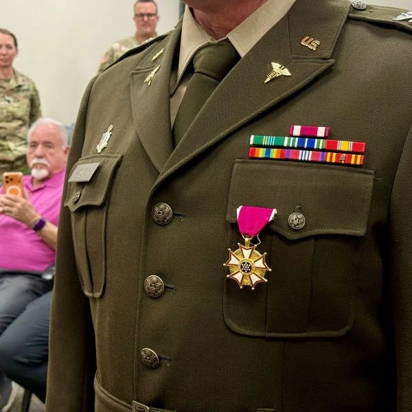 A military officer's dress uniform with a new award pinned to the breast pocket