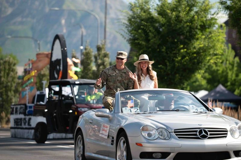 soldier and wife riding in parade