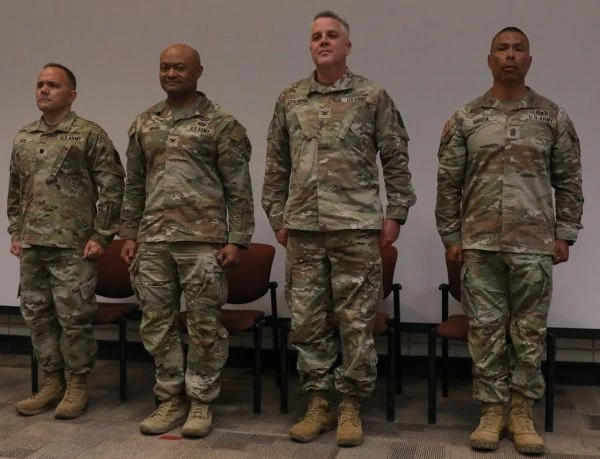Soldiers stand on a stage
