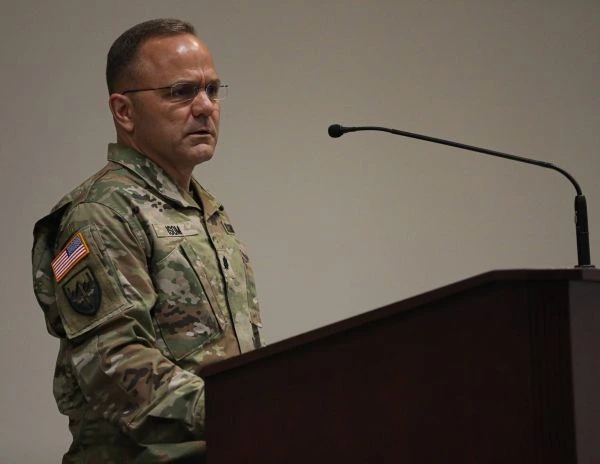 A soldier speaks at a podium
