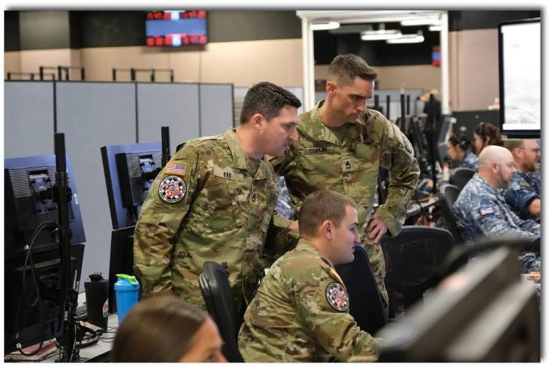 Soldiers gathered around a computer