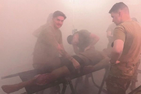 Soldiers working with an injured dummy