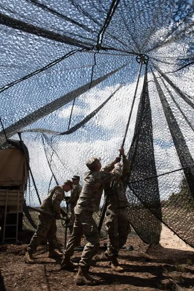 Servicemembers stand up netting