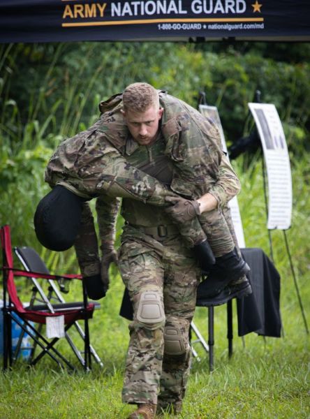 Soldier carrying another soldier on shoulders