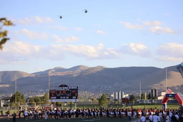 Helicopters flying over a high school stadium