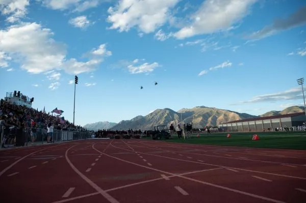Low-angle view of helicopters over a stadium track
