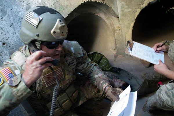 A soldier relays instructions on a military radio system