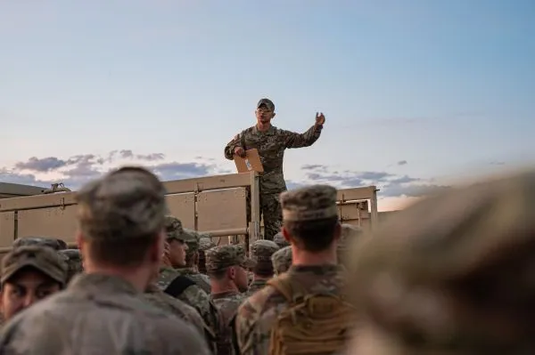 Army instructor briefing Soldiers from the back of a military vehicle during a Combat Field Test